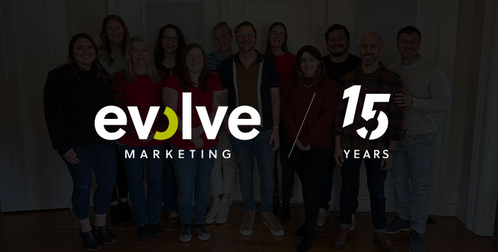 The Evolve Marketing logo and 15 years graphic over a photo of the members of the Evolve Marketing team.