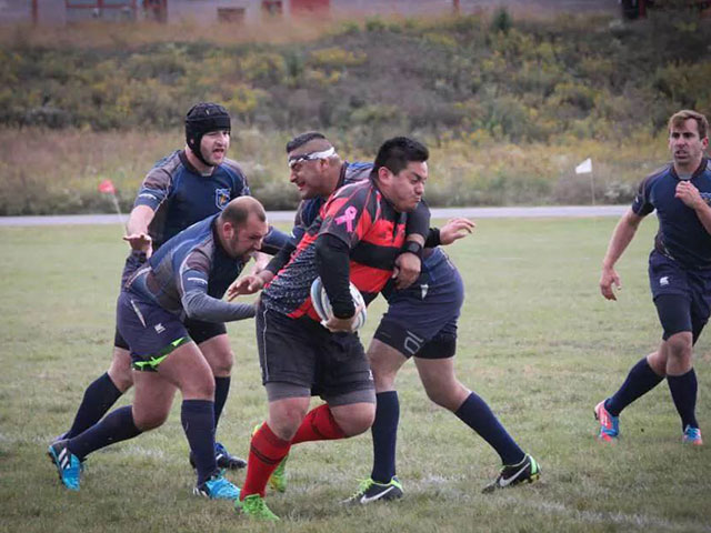 Alex running the ball up the Rugby field.