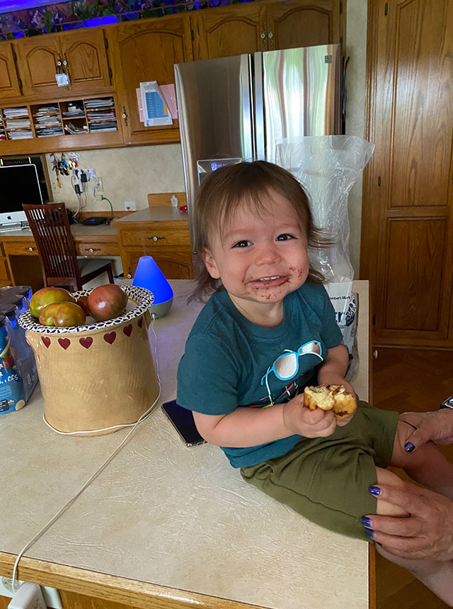 Alex son smiling with chocolate over his mouth.