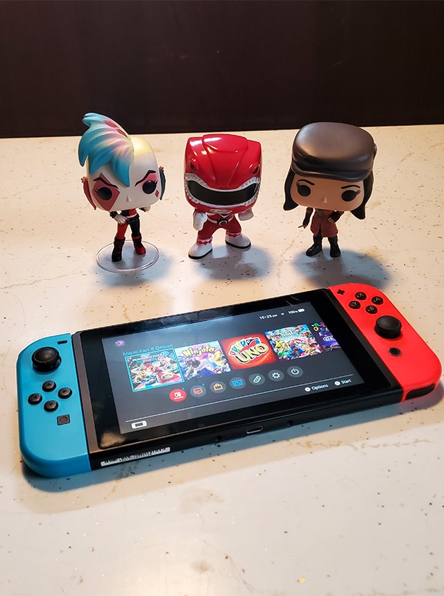 Nintendo Switch with three pop figures.