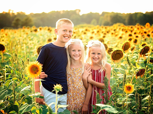 Kids out in a field full of flowers