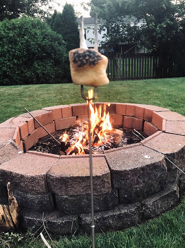 Roasting marshmellow outside in front of a fire pit