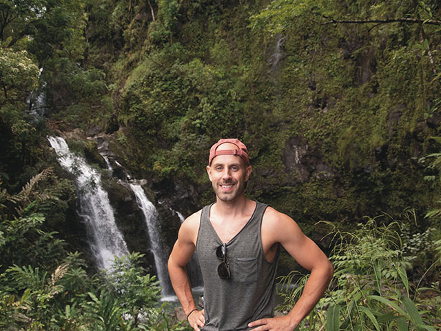 Donny in front of a waterfall.