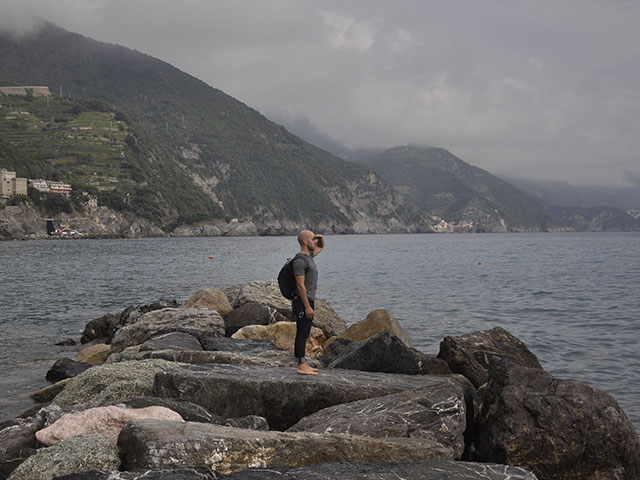 Donny standing on plateau of rocks admiring Pacific coast line