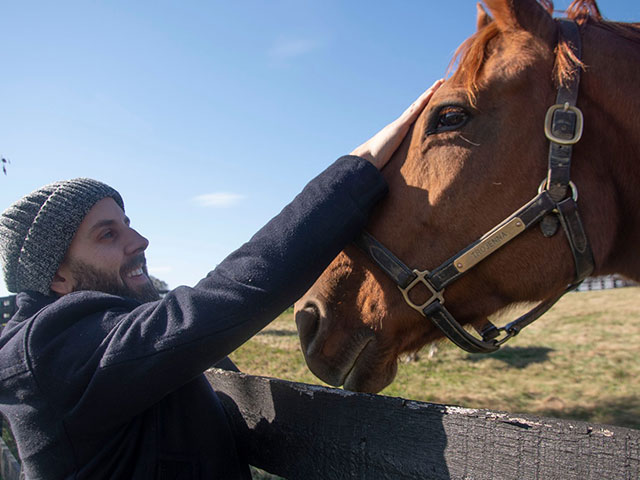 Donny petting new horse friend