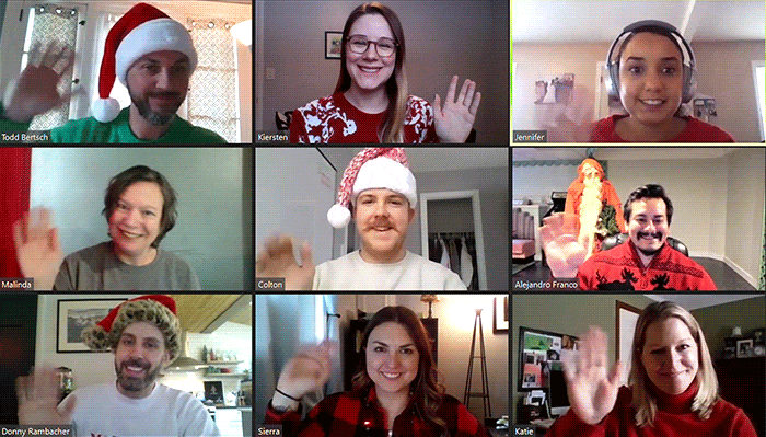 Evolve team waves at the camera while wearing holiday gear