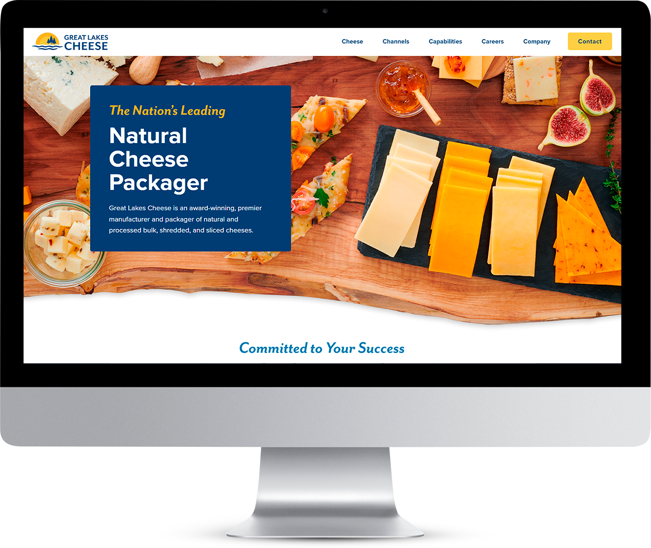 Computer monitor displaying the Great Lakes Cheese website, which showcases slices of cheese, jam, and fruit and the heading: The Nation’s Leading Natural Cheese Packager.