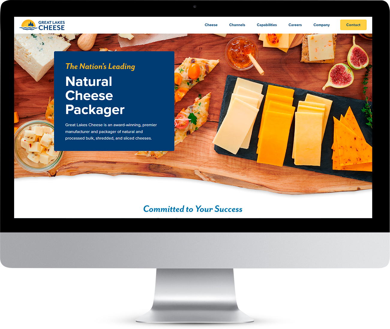 Computer monitor displaying the Great Lakes Cheese website, which showcases slices of cheese, jam, and fruit and the heading: The Nation’s Leading Natural Cheese Packager.