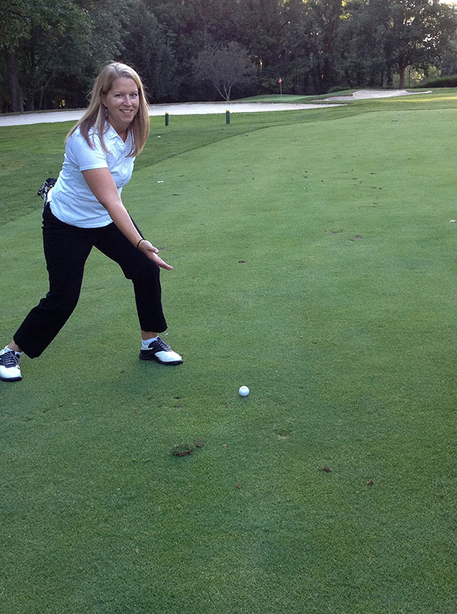 Katie posing by great golf shot