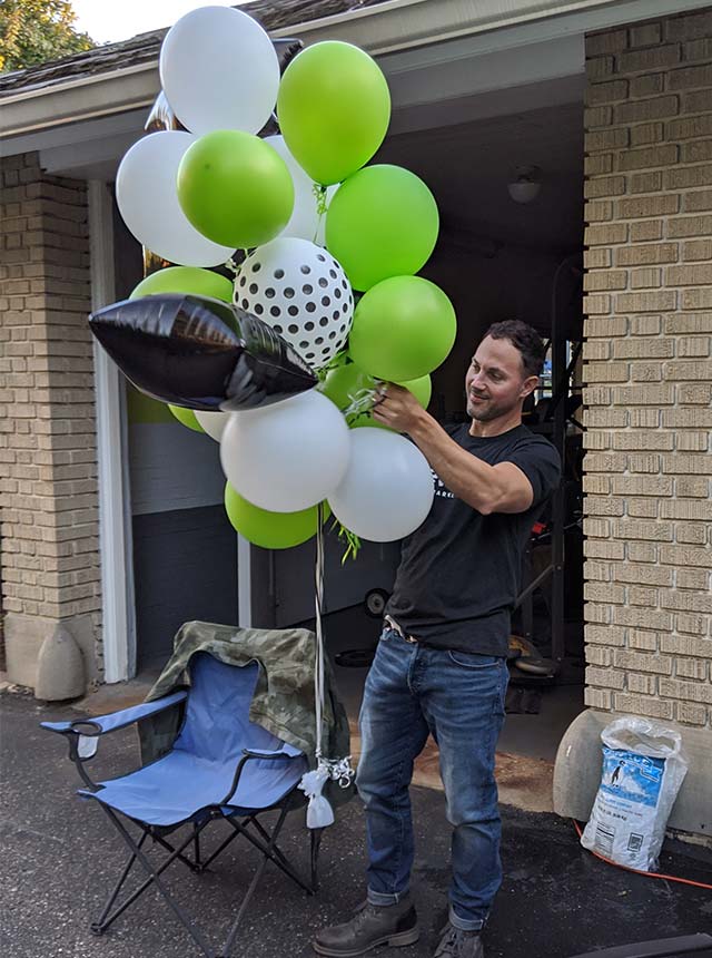 Todd setting up balloons for party