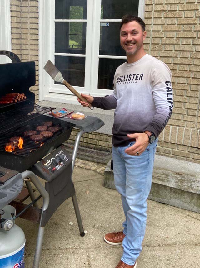 Todd cooking some dogs and burgs