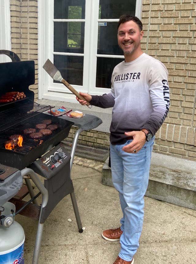 Todd cooking some dogs and burgs