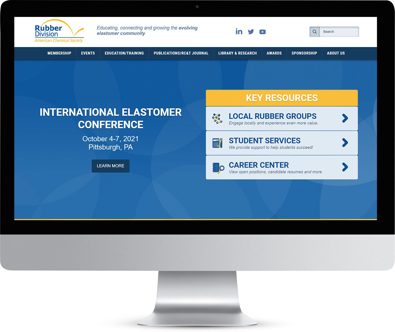 Rubber Division website homepage showing on a monitor screen