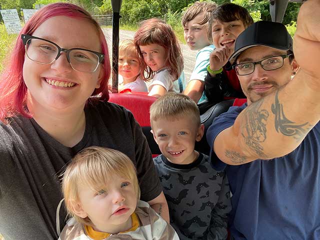 Family photo riding the kids train